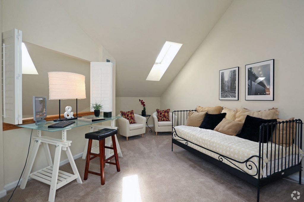 a bedroom with a crib and a desk in a loft