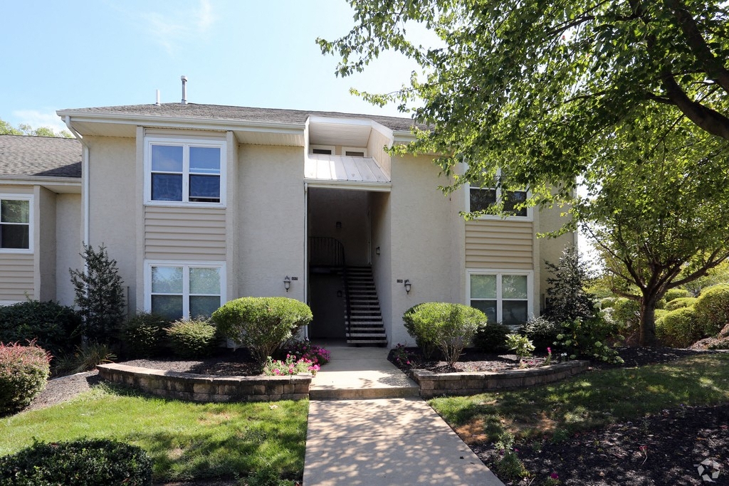 a white house with a sidewalk in front of it