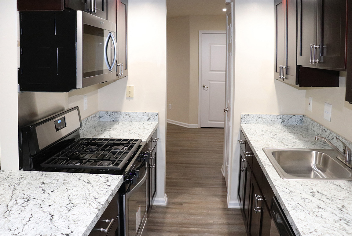 a kitchen with granite counter tops and stainless steel appliances and a sink