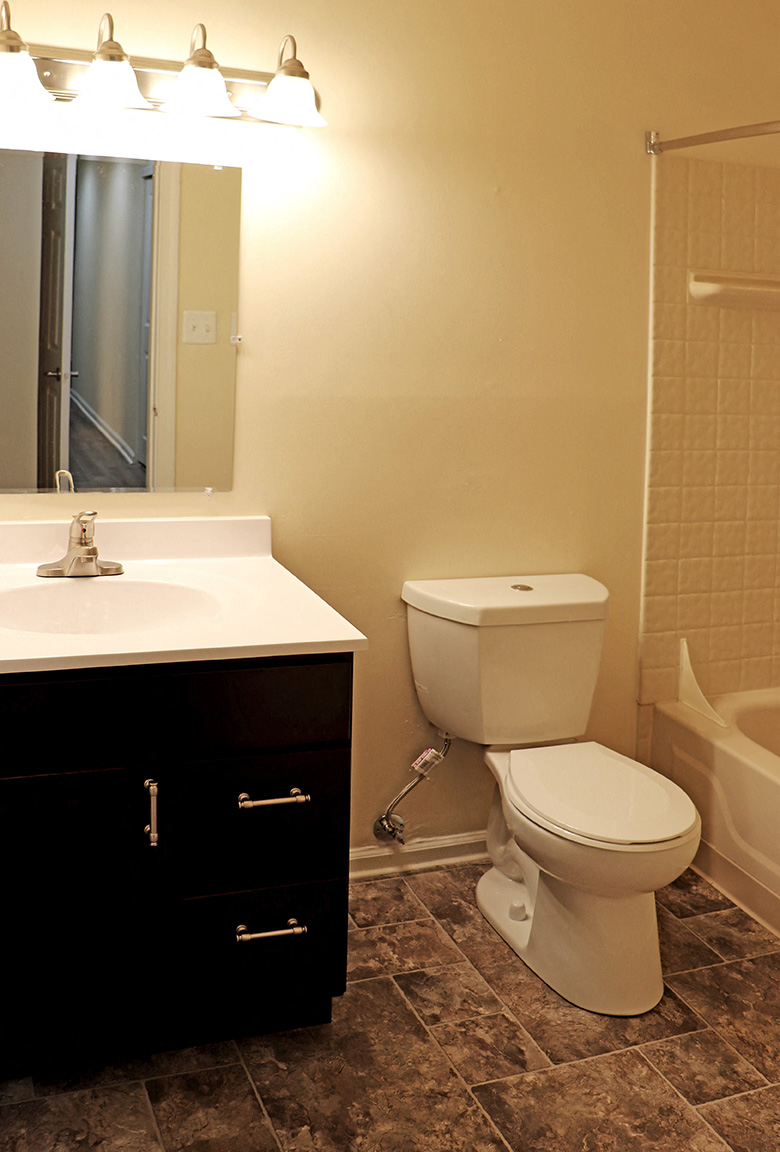 a bathroom with a toilet and a sink and a shower