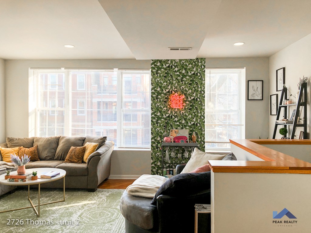 a living room with a couch and a table and a window