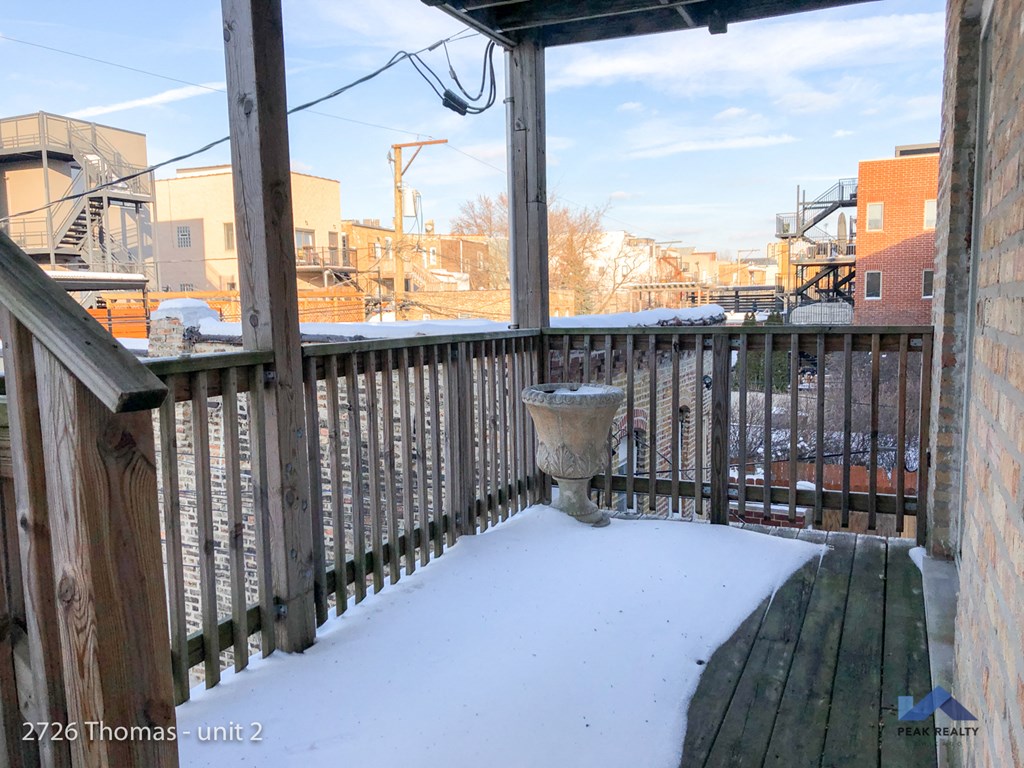 the deck is covered in snow with the city in the background