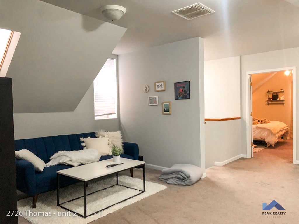 a living room with a blue couch and a coffee table