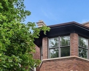 a brick building with a sidewalk in front of it