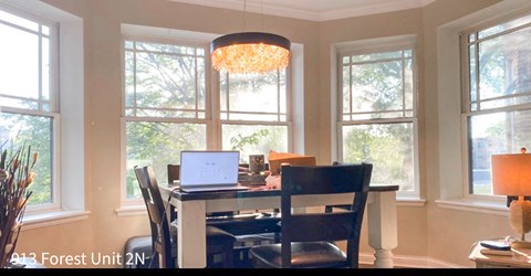 a dining room table with a laptop computer on it