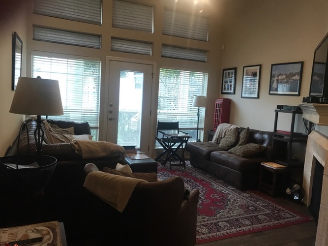 A living room with a fireplace and a couch.
