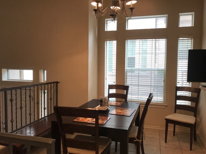 A dining room with a table set for two.