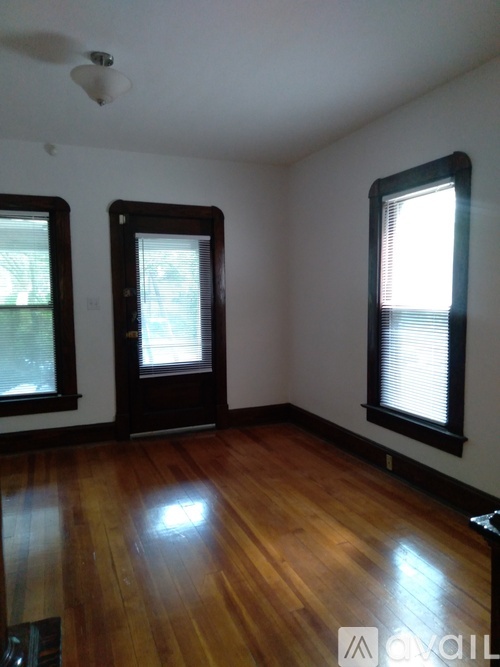 A room with wooden floors and a ceiling fan.