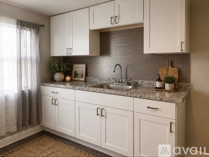 A spacious room with a large window and a door leading to another room.
