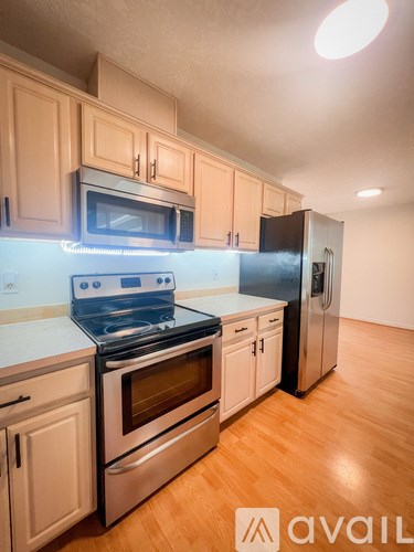 A kitchen with wooden cabinets and stainless steel appliances.