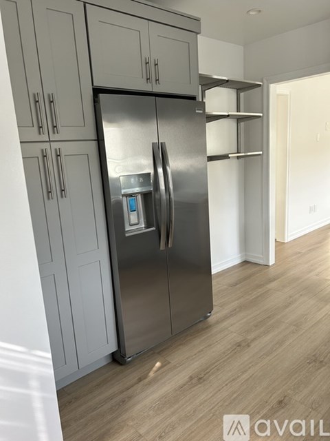 A stainless steel refrigerator with a water and ice dispenser in a kitchen.