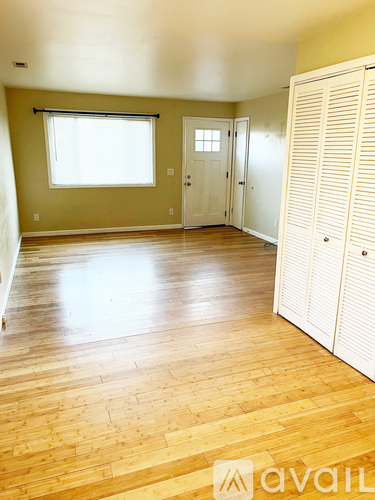 A room with wooden floors and white walls.