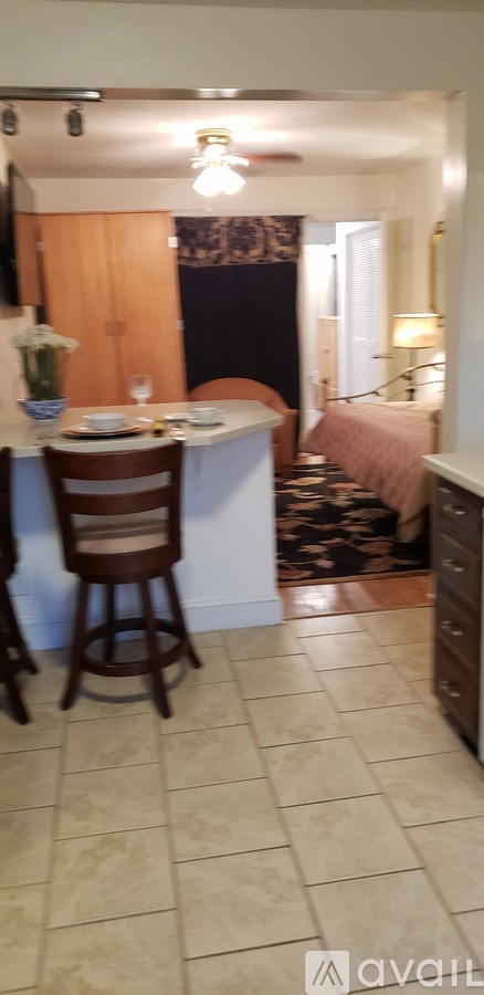 A kitchen with a table and chairs.