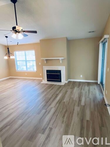 A room with wooden flooring and a ceiling fan.