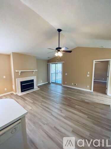 A living room with a fireplace and a sliding glass door.