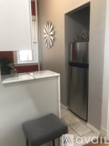 A kitchen with a stainless steel refrigerator and a white countertop.