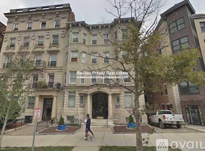 A street view of a building with a sign for Boston Property Real Estate.