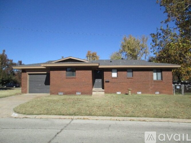 A house with a garage and a driveway in front.