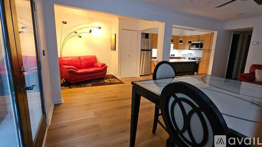 A modern living room with a red couch and a black table.