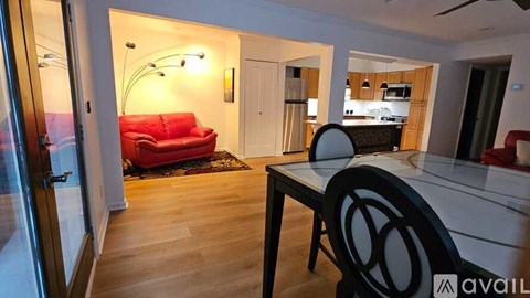 A modern living room with a red couch and a black table.