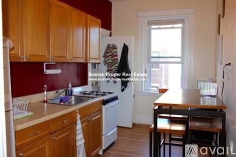 A kitchen with wooden cabinets and a white refrigerator.