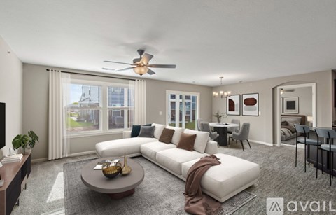 A spacious living room with a white sofa and a coffee table.