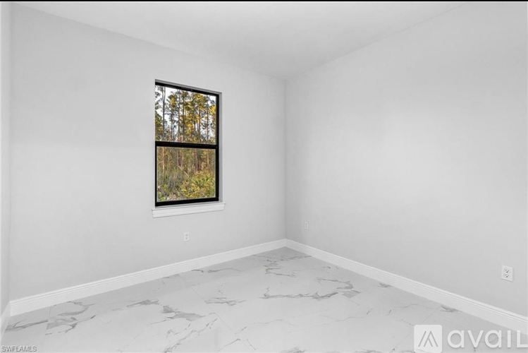 A room with a window and a marble floor.