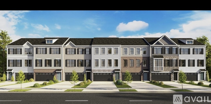 A row of townhouses with garages on the ground floor.