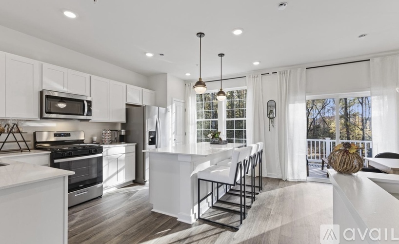 A modern kitchen with white cabinets and a large island.