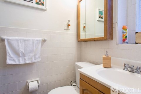 A white towel hangs on a towel rack in a bathroom.