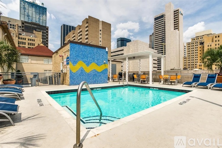 A pool with a blue and yellow mural on the side of a building.