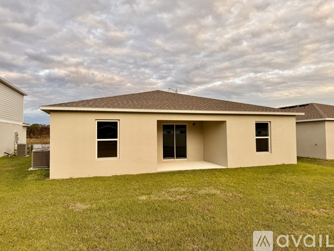 A house with a brown roof and beige walls is available for sale.