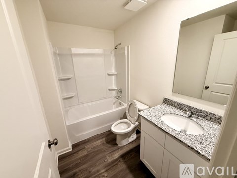 A bathroom with a toilet, sink, and bathtub.