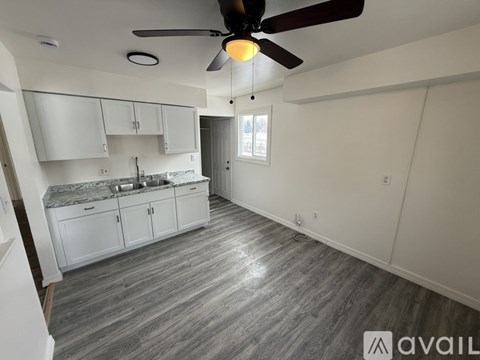 A kitchen with a fan and a countertop.