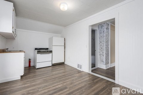 A kitchen with white cabinets and a white stove.