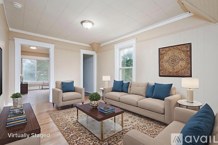 A living room with a couch, chair, and coffee table.