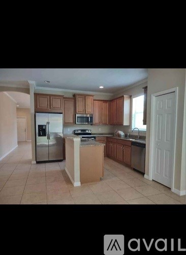 A kitchen with brown cabinets and a white door.
