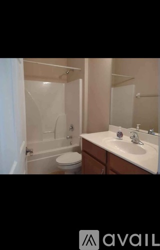 A bathroom with a toilet, sink, and shower.