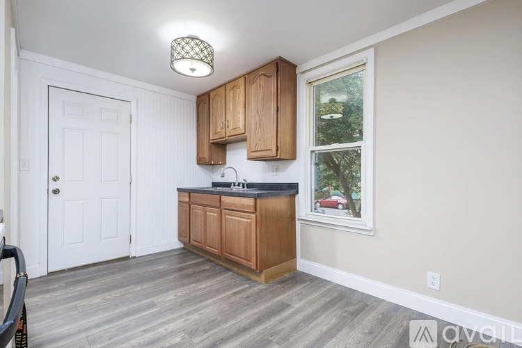 A kitchen with wooden cabinets and a window.