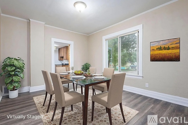 A dining room with a glass table and chairs.