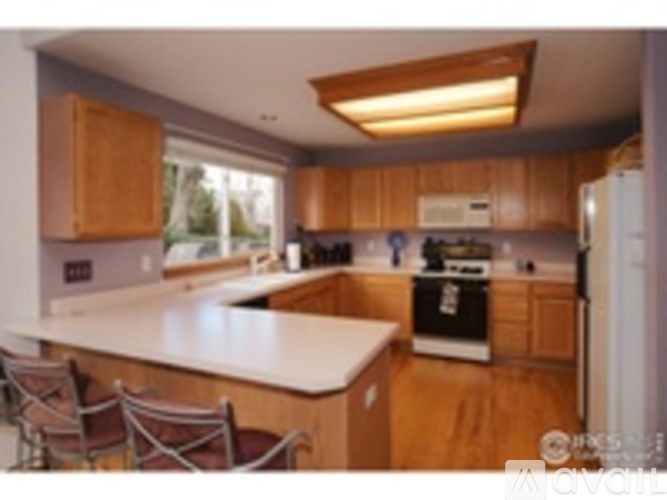 A kitchen with wooden cabinets and a white countertop.