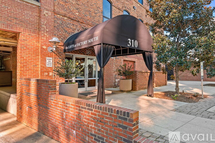 A brick building with a black awning that says 310.