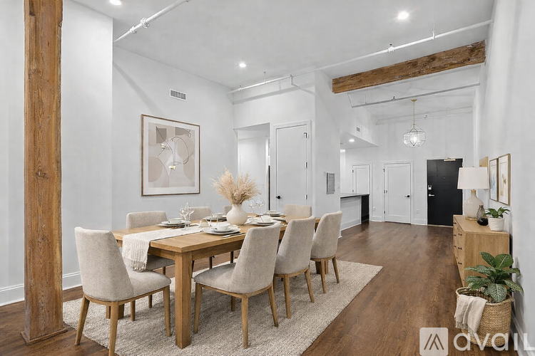 A room with wooden floors and a large wooden beam.