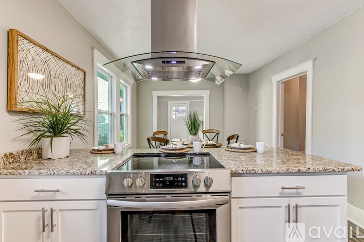 A modern kitchen with a stove top oven and a countertop.