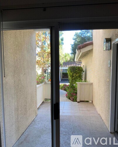 A view from inside a building looking out through a glass door.