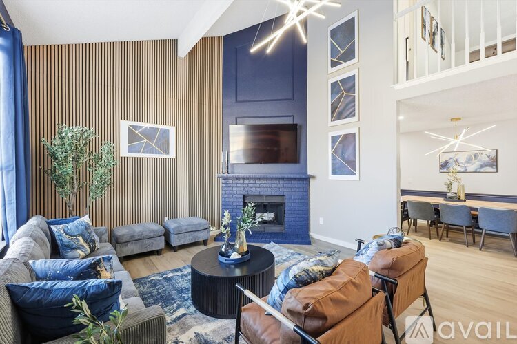 A living room with a fireplace and a television above it.