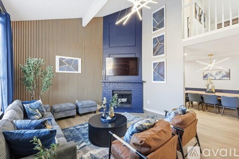 A living room with a fireplace and a television above it.