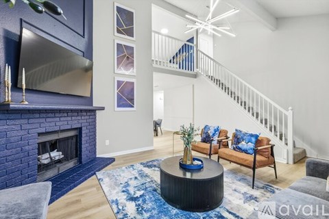 A dining room with a wooden table and blue chairs.