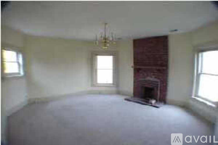 A room with a fireplace and a chandelier.