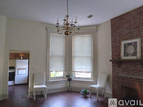 A room with a fireplace and a chandelier.